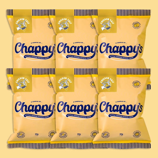 Six packets of Chappy’s Chicken, Salt kettle-cooked potato chips, 85g each, arranged in two rows. Yellow packaging with blue cursive branding, lemon and salt graphics.